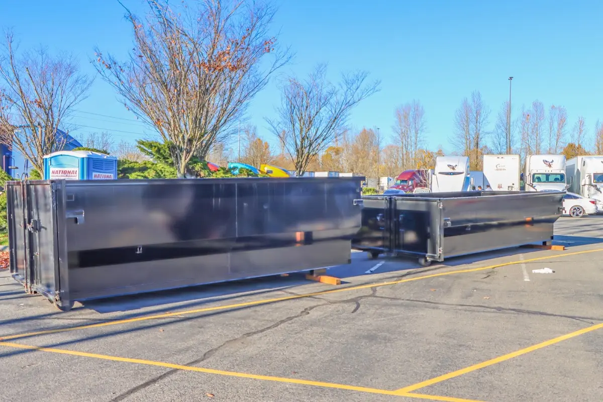 Professional dumpster rental service with roll-off container on residential driveway in Tukwila